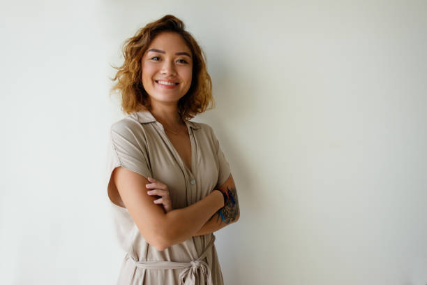 Happy proud girl broadly smiling at camera Happy proud girl broadly smiling at camera. Beautiful young Asian woman posing with arms crossed. Positivity concept asian woman stock pictures, royalty-free photos & images