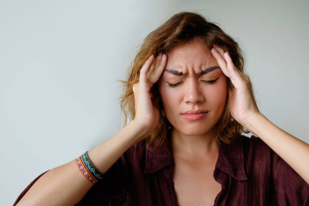 Upset girl suffering from headache