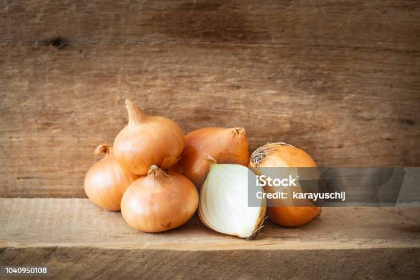 Golden Onions On A Wooden Plank Stock Photo - Download Image Now - Onion, Yellow, Freshness