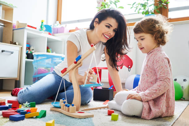 istock Young mother playing with her daughter at her room 1040950502
