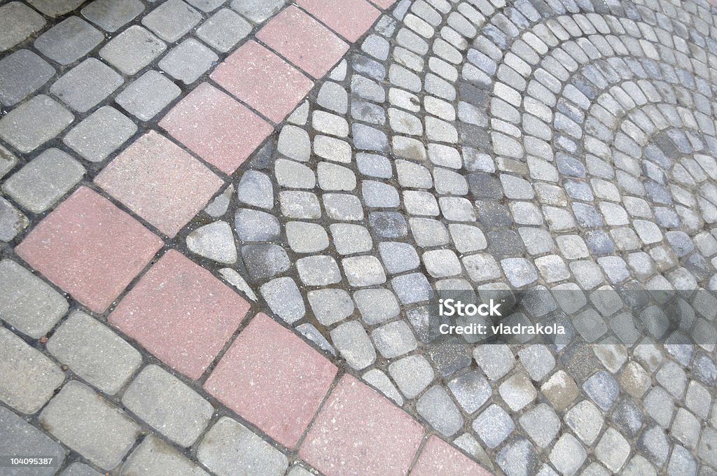 Paving stones forming circles and an arrow.  Acute Angle Stock Photo