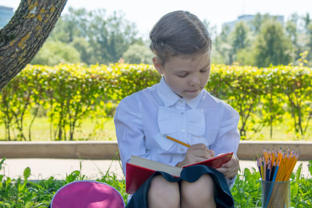 istock the girl is engaged, outdoors, and makes notes in the book 1040961012