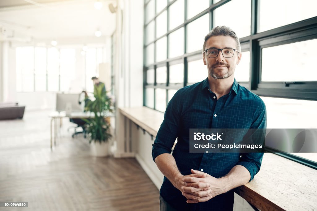 Stay hungry for success Portrait of a confident mature businessman working in a modern office Men Stock Photo