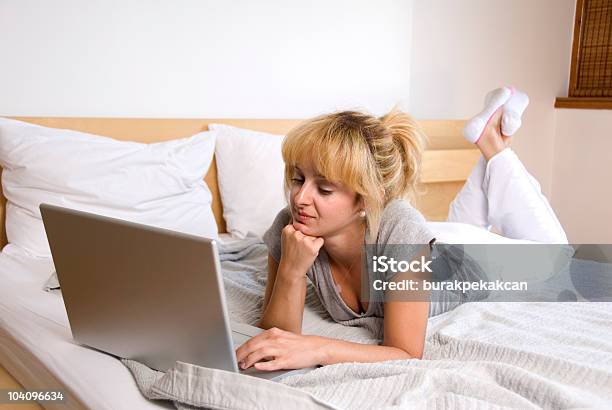 Businesswoman Lying On Bed And Using A Laptop Stock Photo - Download Image Now - 30-39 Years, Adult, Adults Only