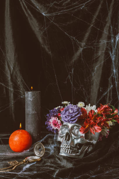 istock silver halloween skull with flowers, vintage clock and candles on black cloth with spider web 1040967000