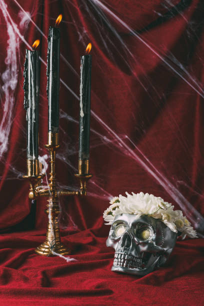 istock silver skull with flowers and candelabrum with candles on red cloth with spider web 1040969516