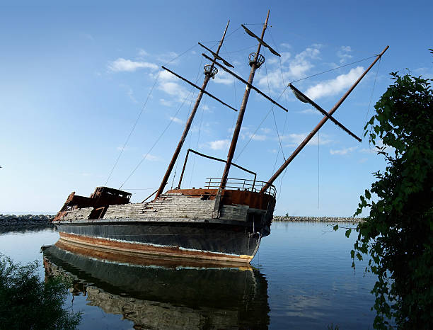 istock Abandonned rusty ship on mirror water in a small creek 104097245
