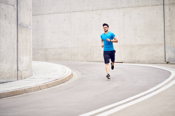 istock Athletic man jogging in the city during outdoors workout session 1040975274