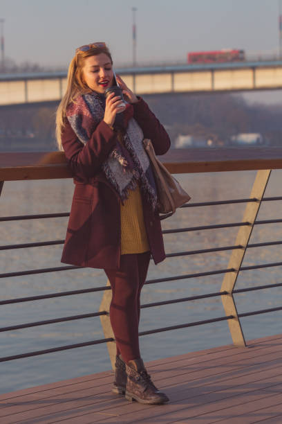 istock Beautiful woman drinking coffee outdoors. 1040975472