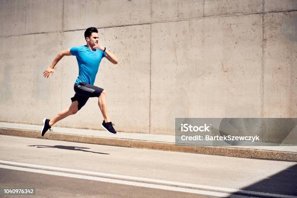 Health And Fitness Concept Man Doing Sprinting And Jumping Exercises During Workout Session In The City Stock Photo - Download Image Now