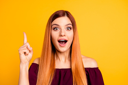 Yes I knew it Close up photo portrait of clever intelligent attractive charming lady with opened mouth looking in camera holding forefinger up isolated bright background.