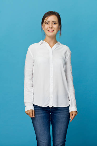 istock Happy young woman smiling against blue background 1040984660