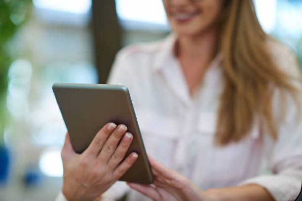 istock Close up of hands holding tablet. 1040990156
