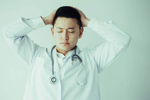 istock Tired Young Male Doctor with Closed Eyes 1040995788