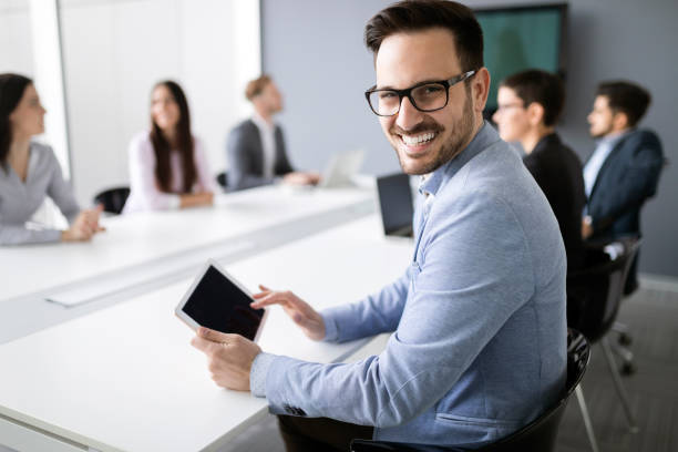 istock Happy young business colleagues in modern office 1040997956