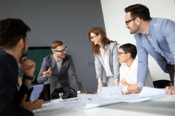 istock Group of architects and business people working together 1041003888