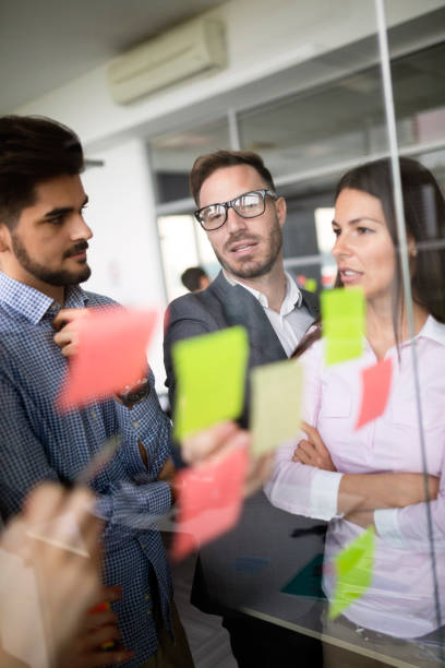 istock Business people meeting at office and use sticky notes to share idea 1041004986