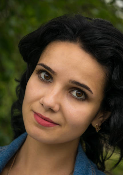 Beautiful young swarthy Middle Eastern girl in denim modern clothes. Modern life in the East