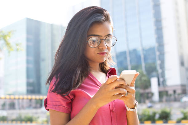 istock Businesswoman text messaging on mobile phone 1041005808