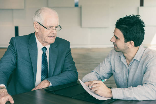 istock Confident manager interviewing senior businessman 1041006234