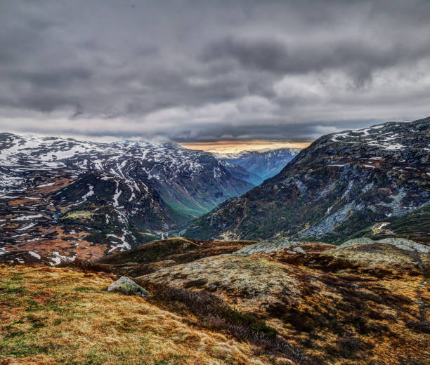 Jotunheimen National park. Gloomy day, 55  tourist road in Norway. Snow, stratus clouds and wind in may