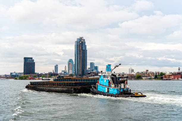 Tugboat pushing barge in East River in New York City