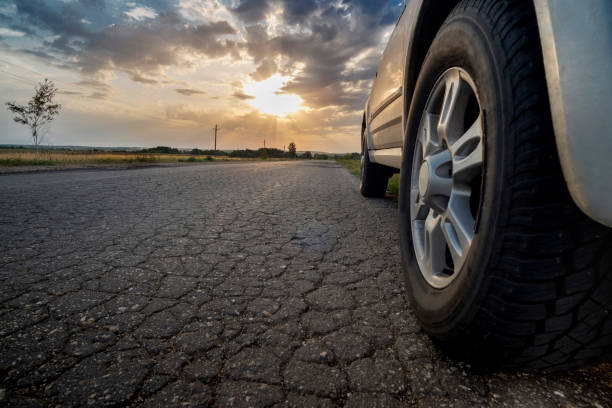 istock Sunset and car on the road 1041014764