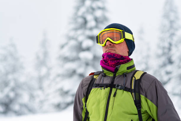 istock Adventurer in goggles stands among huge pine trees 1041014840