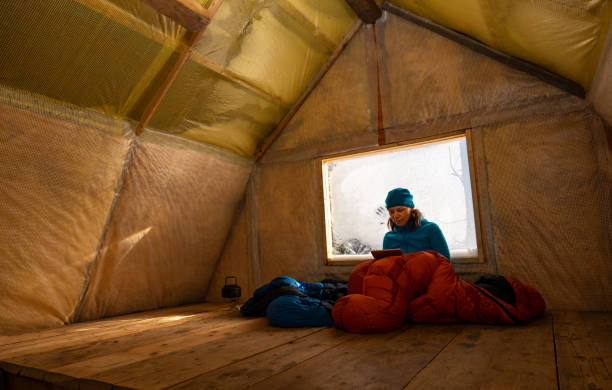 traveler, woman rests in the old mountain hut - home interior cabin shack european alps imagens e fotografias de stock