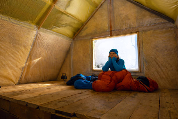happy traveler, woman relaxes in the old mountain hut - home interior cabin shack european alps imagens e fotografias de stock