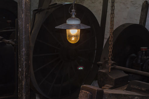 Industrial interior of an old factory. Focus on a lamp