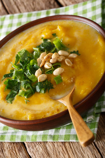 istock Thai pumpkin soup with coconut milk and peanuts close-up. vertical 1041035250