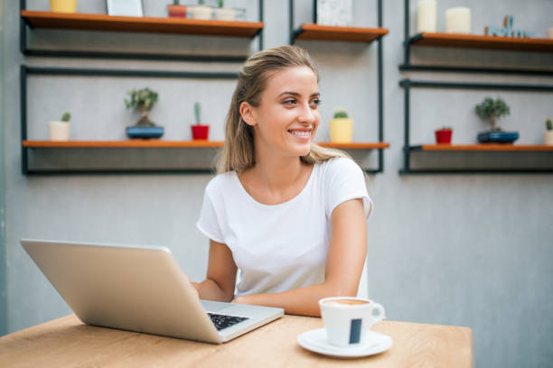 istock Smling girl with laptop looking away. 1041040426