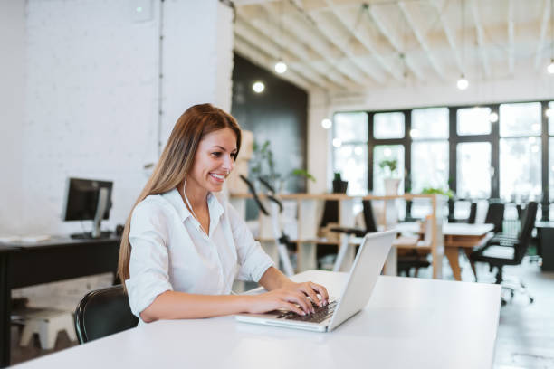 istock Lovely young woman working in modern co-working office. 1041040428