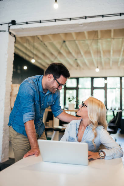 istock Beautiful young coworkers talking at work. 1041040618