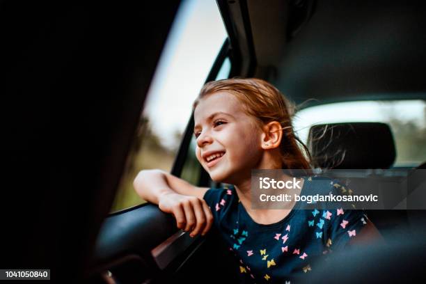 Girl Looking Out Car Window Stock Photo - Download Image Now - Car, Child, Back Seat