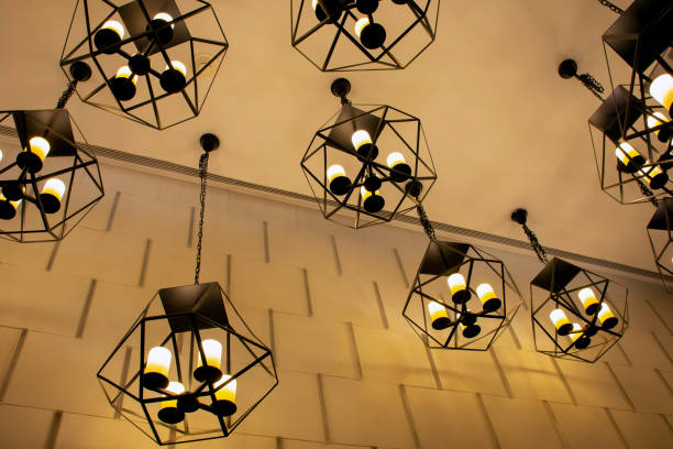istock Modern metallic stylish hang ceiling lamps with beautiful wall background 1041052454