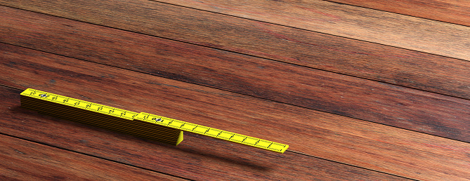 Carpenter folding ruler. Yellow wooden meter isolated on wooden background, banner, copy space. 3d illustration