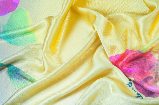 istock Background texture, pattern. silk fabric of yellow color with a floral pattern. Rinse down the memory strip with this nostalgic, multicolored floral pattern with digital printing. 1041061614