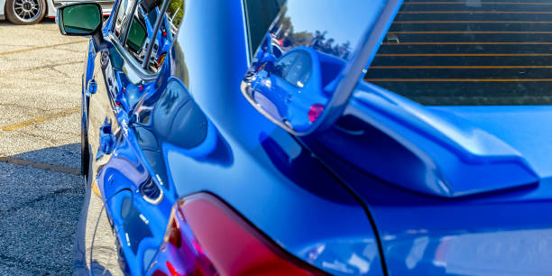 istock Exterior of a blue car reflecting sunlight 1041063054