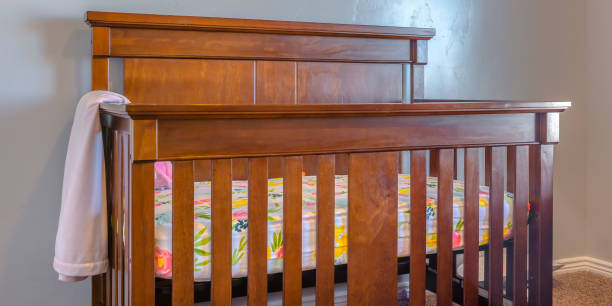 istock Varnished wooden crib inside a nursery 1041063152