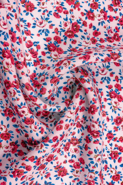 istock Background texture,  thin cotton fabric with small red flowers. Middle weight, quilted cloth or fabric of cotton fabric Small summer flowers, pink, purple, yellow, green leaves, on white background 1041063912