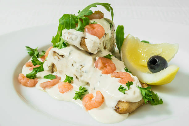 istock Delicious salad with tender shrimps, sauce, herbs and lemon. Horizontal frame 1041064928