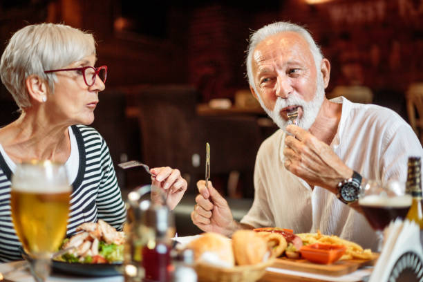 istock Senior couple eating in the restaurant 1041069476