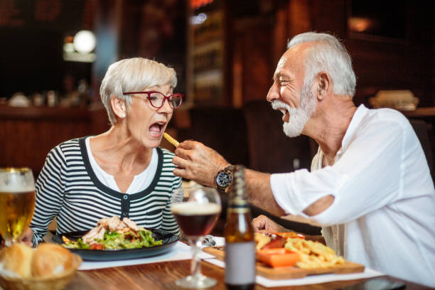 istock Senior man feeding a woman in the restaurant 1041069498