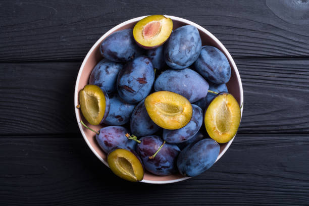 istock Fresh plums in bowl on wooden table 1041071372