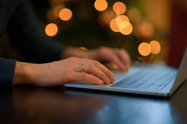 istock man working on a laptop in a cozy Christmas atmosphere 1041081690