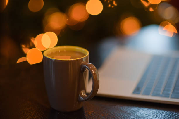 istock man working on a laptop in a cozy Christmas atmosphere 1041081782