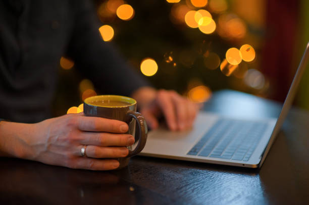 istock man working on a laptop in a cozy Christmas atmosphere 1041081808