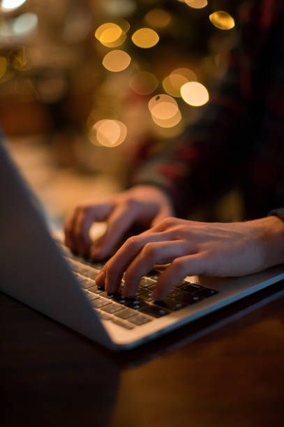 istock man working on a laptop in a cozy Christmas atmosphere 1041081936